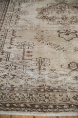 Distressed vintage Oushak rug with even wear to knot heads, faint foundation, beige, brown, ivory tones.