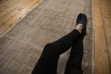 Textured distressed Oushak rug runner with time-softened beige and pale coffee brown tones.