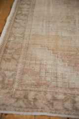 Textured close-up of vintage distressed Oushak rug, showing wear to foundation and knot heads.