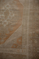 Textured distressed vintage Oushak rug with stepped copper geometric patterns.