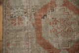 Distressed Oushak rug detail: terra cotta and beige motifs with mostly even wear to knot heads.