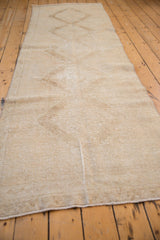 Textured distressed Oushak runner pile in antique ivory and pale coffee brown.