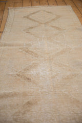 Distressed Oushak runner pile texture with soft ivory tones and zig-zag border.