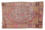 Distressed Vintage Oushak rug, faded pink, plum, and ivory diamond medallion, floral motifs.