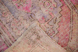 Distressed vintage Oushak rug pile worn to foundation, revealing pale pink, plum tones, and reverse.
