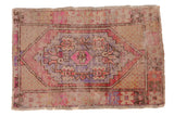 Vintage Distressed Oushak rug with faded pink, blue, ivory diamond medallion and floral border.
