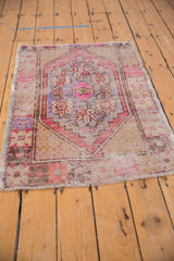 Secured bottom end and visible knot head wear of the distressed vintage Oushak rug.
