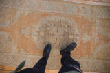 Distressed vintage Oushak runner showing texture and abrashed tangerine, gold, ivory.