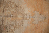 Distressed Oushak rug pile showing even wear, soft tangerine, gold, and ivory tones.