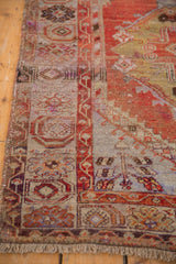 Vintage Oushak rug, mostly even wear on abrashed rust, pale blue pile, with intact selvage.