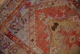 Close-up of vintage Oushak rug showing tree of life motifs, abrashed rust, and blue with even wear.