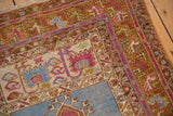 Corner detail of a vintage Oushak showing multi meandering vine borders in saffron, blue, and ochre.