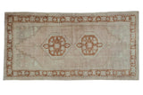 Distressed Vintage Oushak rug, double medallion, stepped spandrels, antique ivory, pale bronze.