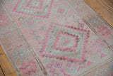 Distressed pink, blush, and silver stepped diamond motifs on the vintage Oushak runner.