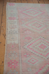 Textured vintage Oushak rug pile with even wear, featuring blush pink and ivory geometric design.
