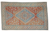 Vintage distressed Oushak carpet with a stepped center medallion in sky blue and brick red.