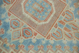 Low pile and even knot-head wear on the stepped medallion of a distressed vintage Oushak.