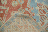 Corner of a vintage Turkish Oushak rug folded to reveal the hand-knotted foundation and weave.