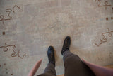 Close-up showing the distressed texture and even wear to the knot heads of a vintage Oushak.