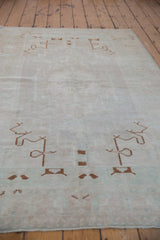 A low perspective highlights the even, distressed wear on this vintage Turkish Oushak rug.