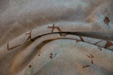 Hand-knotted texture of a distressed Oushak rug showing an even, time-softened wool pile.
