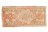 Vintage distressed Oushak rug runner in dusty rose and beige with floral medallion. 1'7