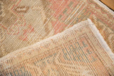Worn pile and hand-knotted foundation with intact selvage on a distressed Oushak rug.