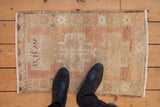 Hand knotted vintage distressed Oushak mat with soft, even wear and muted beige, blush tones.