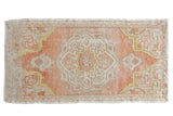 Distressed Oushak rug mat with coral peach field, faded ivory medallion, saffron yellow. 1'7
