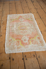 Distressed Oushak rug texture, with worn pile showing foundation and intact side selvage.