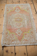 Close-up of vintage Oushak rug's side, showing coral, ivory tones, even wear, and intact selvage.