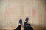 Soft pink and beige distressed Oushak rug with stepped medallion design.