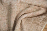 Distressed Oushak rug pile texture with blended dusty rose and beige tones.