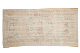 Distressed vintage Oushak runner with a muted rose and powder blue roundel medallion, 2'7