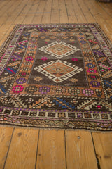 Distressed vintage Oushak rug displaying its double medallion, abrashed ground, and geometric patterns.