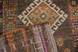 Hand-knotted reverse and distressed Oushak pile, showing purple, fuchsia, and geometric motifs.