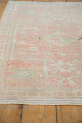 Vintage Oushak rug displaying even wear across knot heads and softened dusty rose tones.