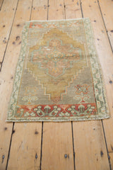 Distressed vintage Oushak rug's lower border, featuring madder root red and subtle germinating plant designs.