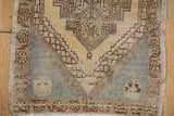 Vintage Oushak rug detail: distressed pile, slate blue field, and meandering palmette border.