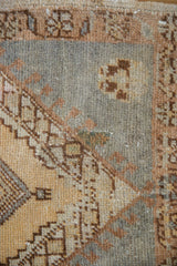 Distressed vintage Oushak rug's muted slate blue field and pale coffee brown palmette detail.