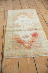 Distressed Oushak rug mat shows worn pile, brick red, mint green patterns, and intact side selvage.