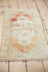 Vintage distressed Oushak rug with germinating rosebush motif, abrash field, and vine border.