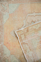 Vintage distressed Oushak rug with mostly even pile wear and woven foundation.