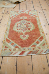 Distressed texture and checker spandrel in brick red and slate blue on Oushak rug mat.