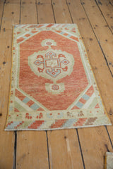 Distressed Oushak rug pile with visible knot wear and intact original side selvage.
