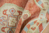 Distressed texture of vintage Oushak rug with brick red and slate blue motifs.