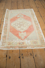 Distressed Oushak rug showcasing uniform faded pile, blush medallion, and geometric border.