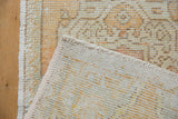Hand-knotted foundation and distressed texture of the vintage Oushak rug mat.