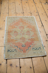 Distressed vintage Oushak rug with apricot stepped pattern and intact side cord selvage.