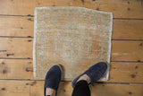 Worn, textured pile of the distressed vintage Oushak rug in soft ivory, beige, and slate.